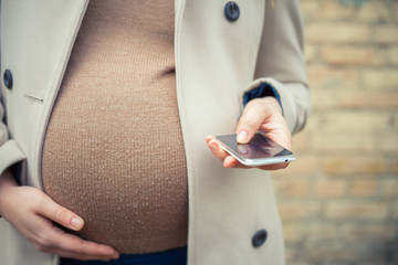 pregnant woman calling by mobile phone