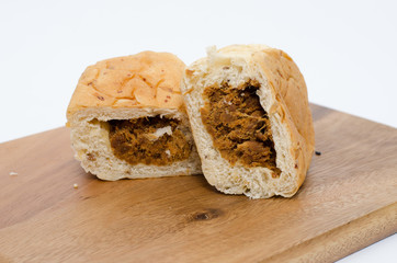 dried shredded pork bread on cutting board on a white background