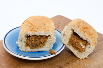 dried shredded pork bread on cutting board on a white background
