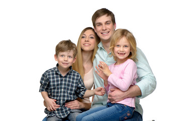 Smiling young family of four posing