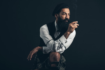 Handsome bearded Scotsman smoking a cigarette