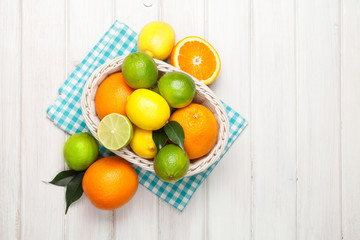 Citrus fruits in basket. Oranges, limes and lemons