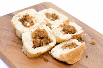 dried shredded pork bread on cutting board on a white background