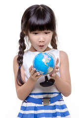 Little Asian girl looking and holding the globe