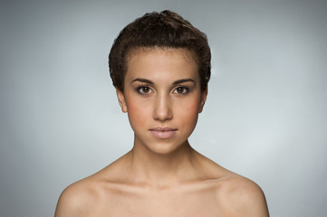 Beautiful brown-eyed natural girl on gray background