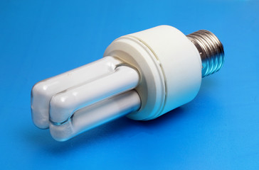 energy saving light bulb on blue background