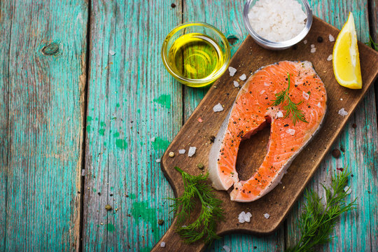 fresh raw salmon steak with herbs and spices