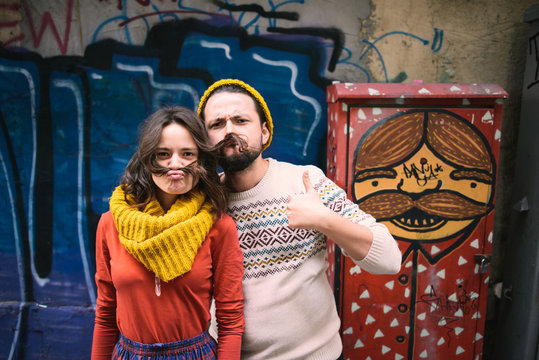 Stylish couple with mustache on