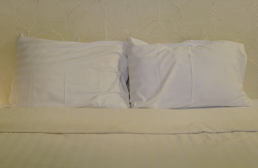Fototapeta na wymiar White pillows on bed