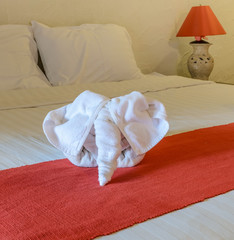 Fototapeta na wymiar White towel in form of elephant on bed