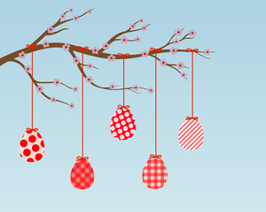 branch with blossoms and red easter eggs