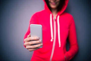 Closeup image of a girl holding smartphone