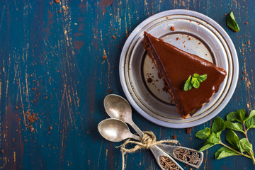 piece of chocolate cake with mint leaves, top view