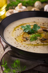 Mushroom cream soup on rustic background