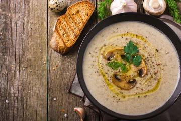 Mushroom cream soup on rustic background