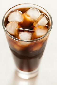 Cola cold sweet soda beverage  with ice and bubbles in glass