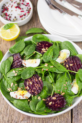 Fresh spinach salad, eggs and roasted beets