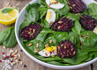 Fototapeta na wymiar Fresh spinach salad, eggs and roasted beets
