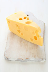Maasdam cheese on a cutting board