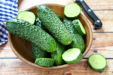 Cucumbers in a bowl on boards