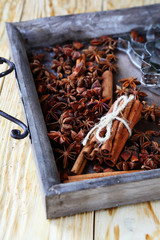 Cinnamon and anise in wooden tray