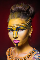 Beautiful woman with tribal face make up