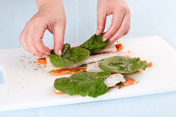 fish rolls with spinach leaves