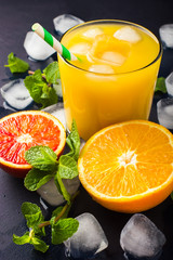 Fresh orange juice on dark background