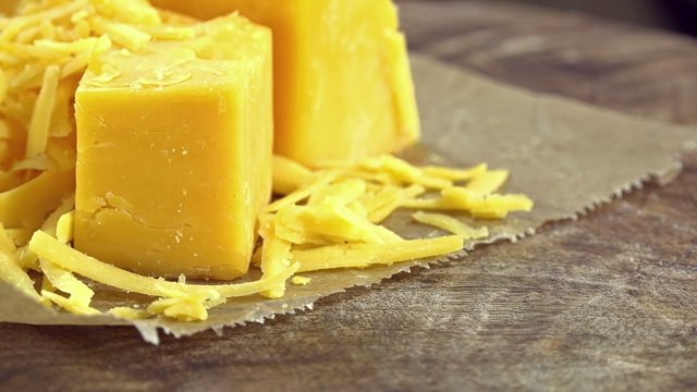 Rotating grated Cheddar (not loopable 4K UHD footage)