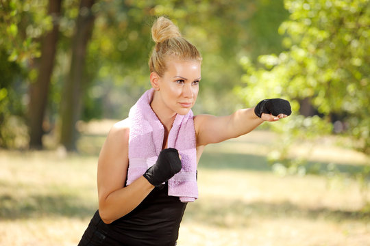 Girl in boxing guard exercise in the park