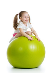 Fototapeta na wymiar child girl doing fitness exercise with fitness ball