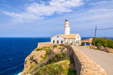 Fototapeta na wymiar Lighthouse on cliff edge, Cala Ratjada, Majorca island, Spain