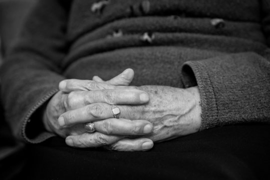 old woman's hands joined