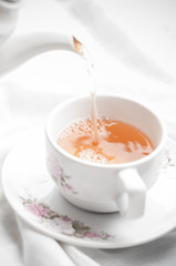 Tea being poured into tea cup