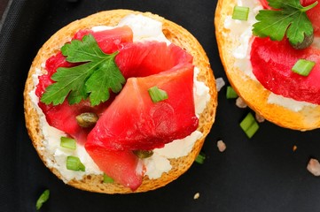 Sandwiches with gravlax, parsley, scallion and cream cheese on b