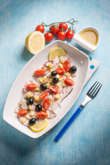 octopus salad with cherry tomatoes and black olives