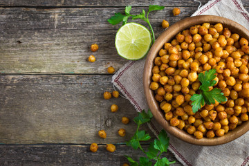 Roasted  spicy chickpeas on rustic background © anna_shepulova