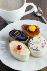 variety of delicious mini cakes on a plate