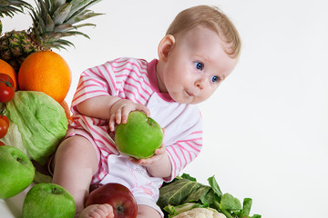 Fototapeta premium Cute baby sitting with fruits and vegetables