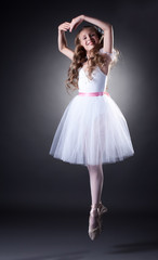 Naklejka premium Emotional young ballet dancer posing in jump