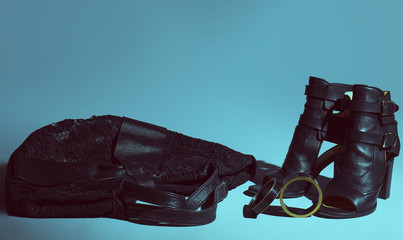 Trendy women's shoes with bracelet over  blue background.