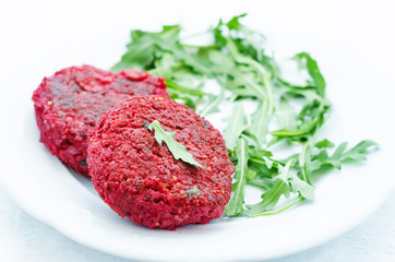 chickpeas, quinoa and beet burgers with arugula