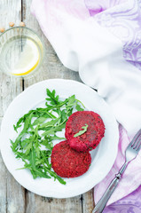 chickpeas, quinoa and beet burgers with arugula