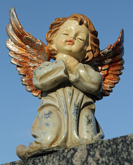 angelic sweet figurine with colorful wings isolated on sky