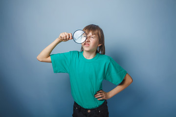 teenager boy brown European appearance in a green T-shirt put hi