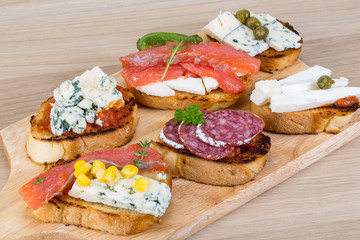 Tapas with cheese, salami and salmon