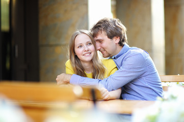 Young couple in the outdoor cafe
