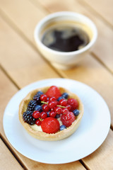 Custard fruit tart and cup of coffee