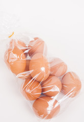 Eggs in a plastic bag on white paper background