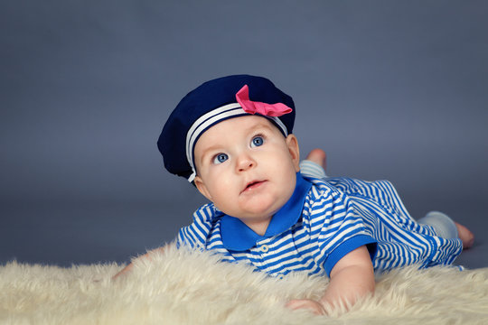 Portrait of happy cute baby girl in sailor dress